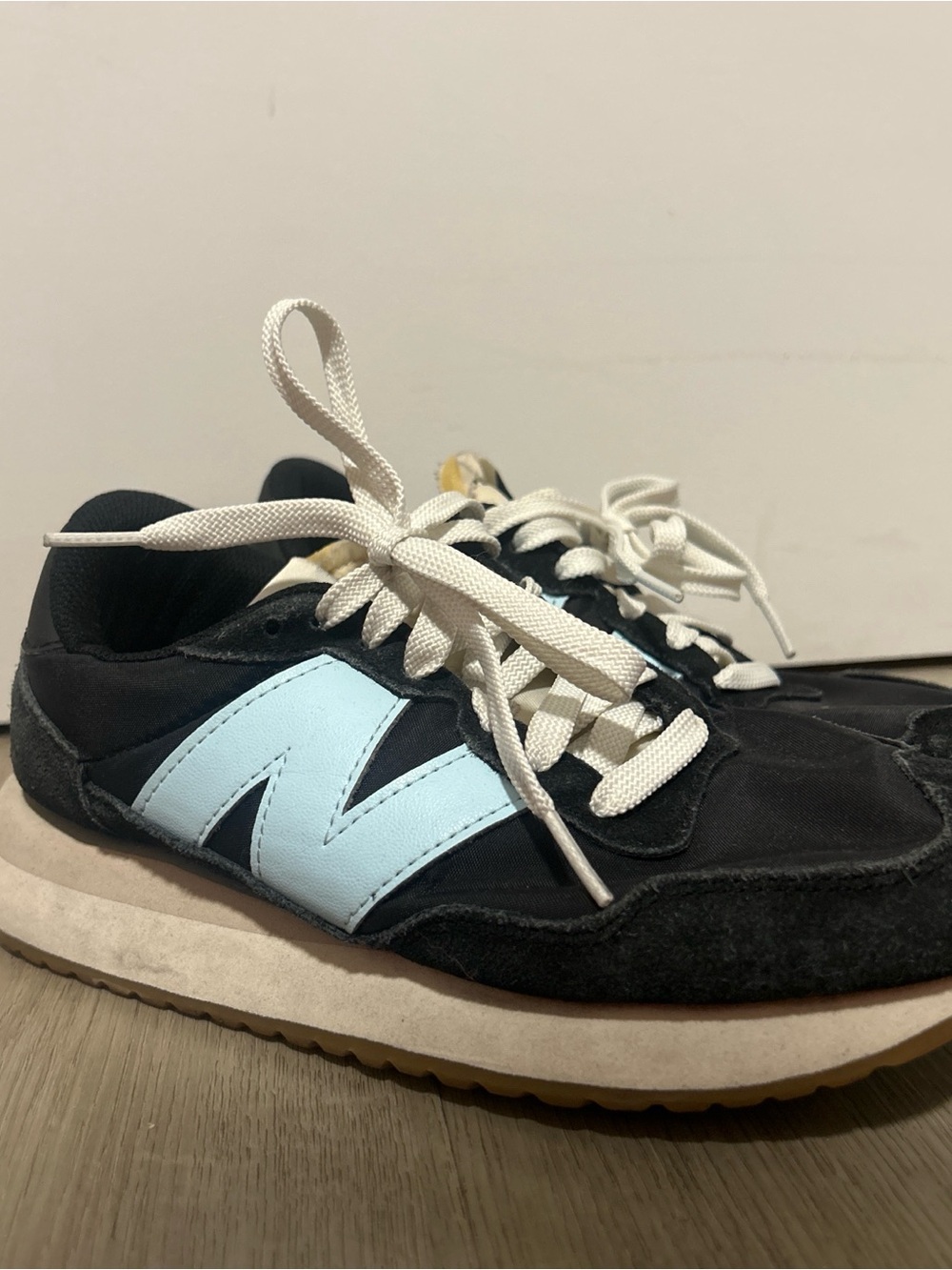 New Balance Black Athletic Sneakers with Light Blue Logo and White Laces